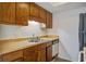 Functional kitchen with wooden cabinets, double sink and white appliances at 205 Weber Rd # B, Summerville, SC 29483