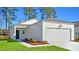 Charming single-story home with a two-car garage, lush landscaping, and a welcoming entrance at 206 Pine Crest View Dr, Summerville, SC 29486