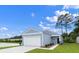 New home with lake view featuring blue siding, a two-car garage, and attractive landscaping at 206 Pine Crest View Dr, Summerville, SC 29486