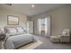Comfortable main bedroom with a large window, a cozy chair, and ample natural light at 206 Pine Crest View Dr, Summerville, SC 29486