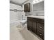 Well-lit bathroom with vanity, tile floors, a combination shower and tub, and white subway tile at 209 E 4Th S St, Summerville, SC 29483