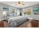 Bedroom with neutral walls and a gray bed with light blue pillows and wooden floors at 209 E 4Th S St, Summerville, SC 29483