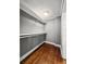 Empty walk in closet with wooden floors and white shelving on gray walls at 209 E 4Th S St, Summerville, SC 29483
