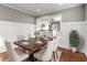 Elegant dining room with a dark wood table, upholstered chairs, and view to bright kitchen at 209 E 4Th S St, Summerville, SC 29483