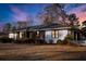 Charming single-story home featuring a mix of brick and siding with a well-manicured lawn and lush landscaping at 209 E 4Th S St, Summerville, SC 29483