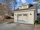 Detached garage with a dormer window and carriage style doors at 209 E 4Th S St, Summerville, SC 29483