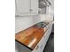 Kitchen wooden countertop and stainless steel stovetop with white tiled backsplash at 209 E 4Th S St, Summerville, SC 29483