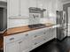 Stainless steel refrigerator and stove top with light cabinets and wooden countertops at 209 E 4Th S St, Summerville, SC 29483