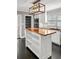 Stylish kitchen island featuring butcher block countertop, white shelving, and modern finishes at 209 E 4Th S St, Summerville, SC 29483