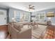 Bright living room with hardwood floors, neutral furniture, and large windows at 209 E 4Th S St, Summerville, SC 29483