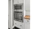 Modern stainless steel oven and microwave combo, set within custom white cabinetry in the kitchen at 209 E 4Th S St, Summerville, SC 29483