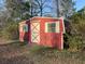 Exterior view of a red shed surrounded by greenery at 209 E 4Th S St, Summerville, SC 29483