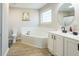 Bright primary bathroom with soaking tub, dual vanities and a window at 215 Evesham Dr, Summerville, SC 29485