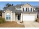 Charming two-story home featuring a two-car garage, black door, and neutral-toned siding at 215 Evesham Dr, Summerville, SC 29485