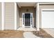 Inviting front entry with a black door, white trim, and house number detail at 215 Evesham Dr, Summerville, SC 29485