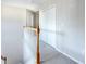Hallway features neutral paint, carpet and natural stained wood railing at 215 Evesham Dr, Summerville, SC 29485