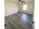 Bedroom featuring new gray flooring, ceiling fan, fresh paint, and natural light at 2219 N Dallerton Cir, Charleston, SC 29414