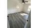 Bright bedroom featuring stylish gray floors, a ceiling fan, and two well-lit windows at 2219 N Dallerton Cir, Charleston, SC 29414