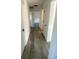 Hallway with new gray flooring, white walls, and modern black door hardware at 2219 N Dallerton Cir, Charleston, SC 29414