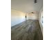 Bright living room featuring new gray flooring, ceiling fan, and natural light at 2219 N Dallerton Cir, Charleston, SC 29414