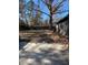 Spacious backyard with a patio area, mature trees, and a glimpse of the home's exterior at 222 Braly Dr, Summerville, SC 29485
