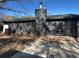 Backyard view of the home with a dark exterior, leading to a patio and yard area at 222 Braly Dr, Summerville, SC 29485