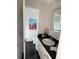 Modern bathroom featuring a sleek vanity, black tile floor, and a stylish mirror at 222 Braly Dr, Summerville, SC 29485