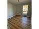 Cozy bedroom with hardwood flooring, a large window with natural light, and neutral paint at 222 Braly Dr, Summerville, SC 29485