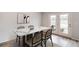 Dining area with modern table and chairs and beautiful lighting is perfect for Gathering meals at 223 West Bradford Pointe Dr, Summerville, SC 29486