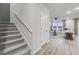 Stylish staircase leading to a bright living room, enhanced by wood-look floors at 223 West Bradford Pointe Dr, Summerville, SC 29486
