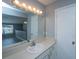 Bathroom vanity featuring a wide mirror with strip lighting and a view into the upstairs bedroom at 2494 Etiwan Ave # B-4, Charleston, SC 29414