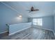 A cozy bedroom with wood-look flooring, a modern ceiling fan, and a bright window for natural light at 2494 Etiwan Ave # B-4, Charleston, SC 29414