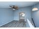 Bedroom with wood-look floors, ceiling fan, pendant lighting, and an open view to the en-suite bathroom at 2494 Etiwan Ave # B-4, Charleston, SC 29414