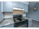 Kitchen featuring gray cabinets, dark appliances, and granite countertops at 2494 Etiwan Ave # B-4, Charleston, SC 29414