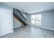 View of living room featuring stairs, light grey walls, modern flooring, and natural light at 2494 Etiwan Ave # B-4, Charleston, SC 29414