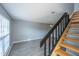 View of living room with stairway, light grey walls, light fixtures, and modern flooring at 2494 Etiwan Ave # B-4, Charleston, SC 29414