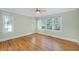 Sun-drenched bedroom with hardwood floors, large windows, and white trim at 2734 Old Forest Drive, Seabrook Island, SC 29455