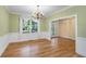 Light-filled dining room with hardwood floors, wainscoting and an elegant chandelier at 2734 Old Forest Drive, Seabrook Island, SC 29455