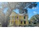 Two-story home with yellow siding and a second-story balcony at 2982 Lodge Berry Ln, Johns Island, SC 29455