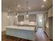 Modern kitchen with a large island, gray cabinetry, stainless steel appliances, and hardwood flooring at 2982 Lodge Berry Ln, Johns Island, SC 29455