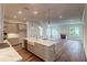 Open concept kitchen and living room with fireplace and expansive windows at 2982 Lodge Berry Ln, Johns Island, SC 29455