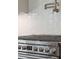 Close-up of stainless steel range with white subway tile backsplash and pot filler faucet at 2982 Lodge Berry Ln, Johns Island, SC 29455