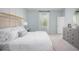 Serene bedroom featuring a wicker headboard, a gray dresser, and lots of natural light at 300 Pine Crest View Dr, Summerville, SC 29486