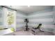 Bright exercise room with a stationary bike, weight bench, and natural light from the window at 300 Pine Crest View Dr, Summerville, SC 29486