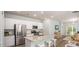 Bright open-concept kitchen with stainless appliances, island, adjacent living area, and sliding glass doors to the patio at 300 Pine Crest View Dr, Summerville, SC 29486