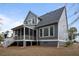Home's rear exterior with a screened porch, deck, and backyard at 3004 Riverwood Dr, Mount Pleasant, SC 29466
