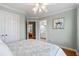 Bright bedroom featuring a ceiling fan, hardwood floors, and ensuite bathroom at 3004 Riverwood Dr, Mount Pleasant, SC 29466