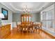 Elegant dining room features a large window, hardwood floors, and a classic chandelier that adds to its charm at 3004 Riverwood Dr, Mount Pleasant, SC 29466