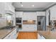 Well-lit kitchen features stainless steel appliances, granite countertops, and hardwood floors at 3004 Riverwood Dr, Mount Pleasant, SC 29466