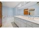 Bright bathroom featuring a double sink vanity, soaking tub, and blue tile accents at 305 Meadowlark Ln, Moncks Corner, SC 29461